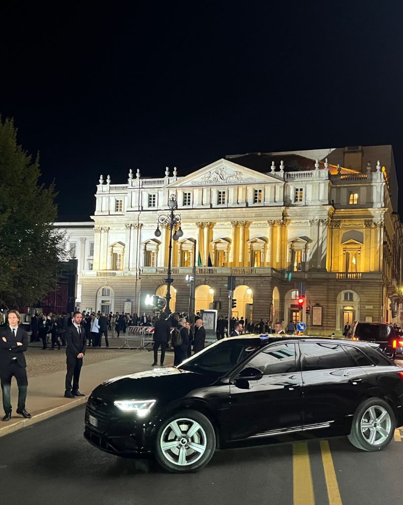 The Exterior of the Teatro all Scala, Milan Italy. With large black car in foreground and security across the front of the building